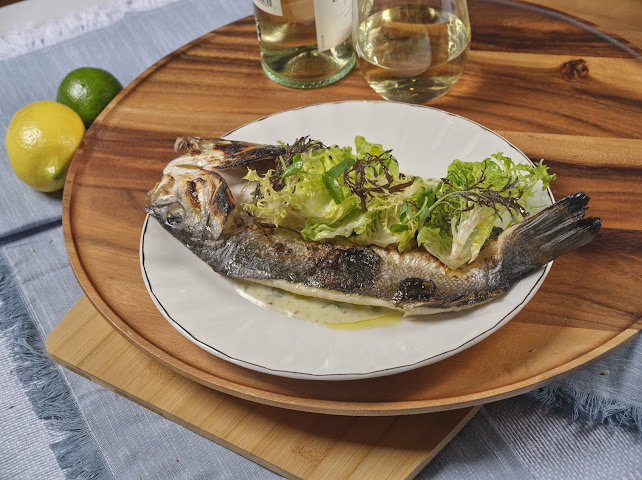 Monterey Bay Branzino — charbroiled whole fish with Meyer lemon beurre blanc and house salad at Prettiplatters