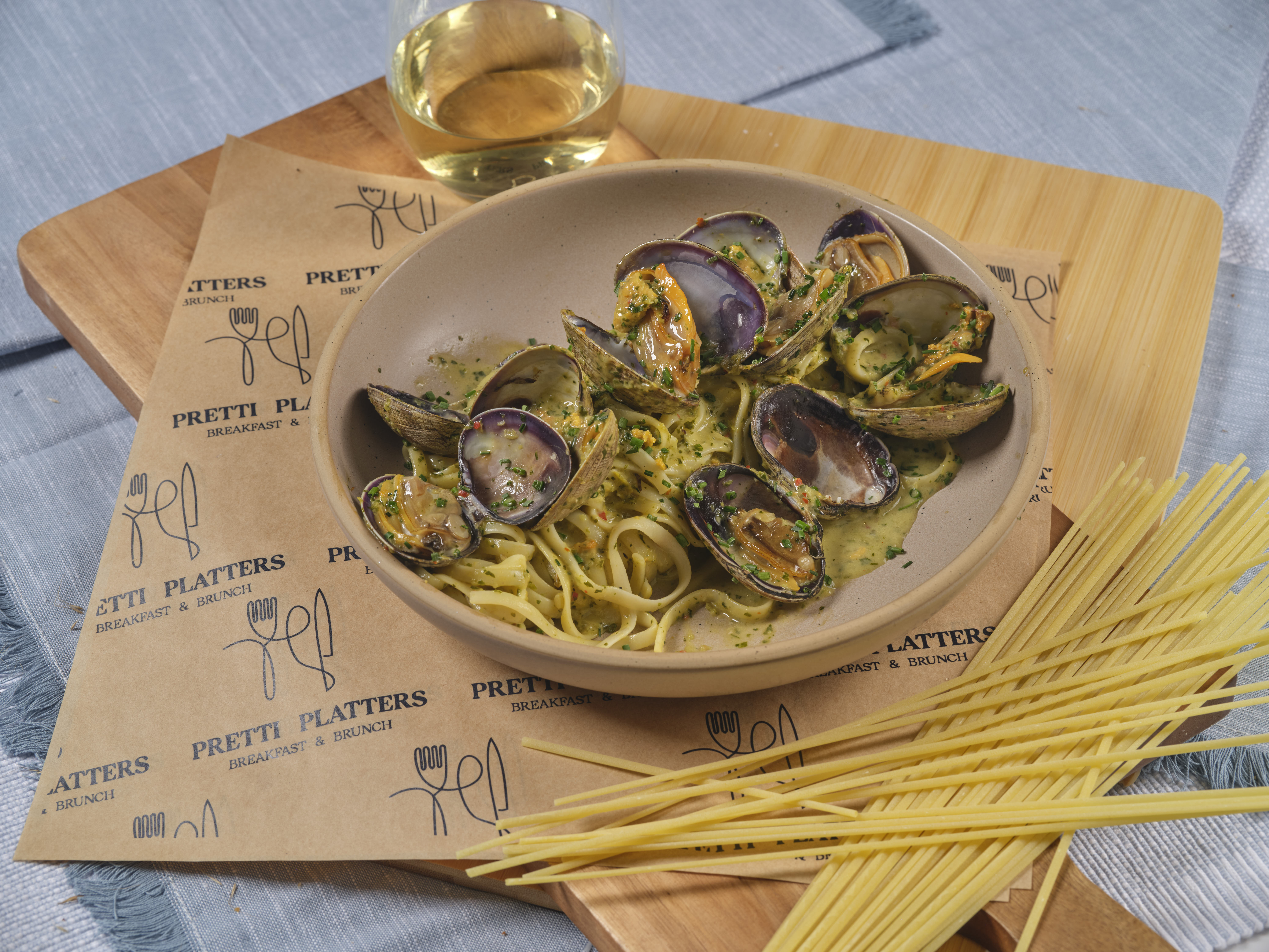 Coastal Clam Linguini with plump Manila clams, salsa verde, and uni cream at Prettiplatters San Anselmo