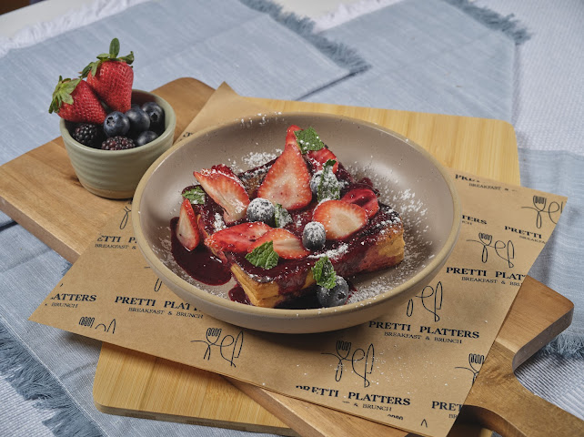 Morning French Toast with fresh strawberries, blueberries, berry coulis, and powdered sugar at Prettiplatters