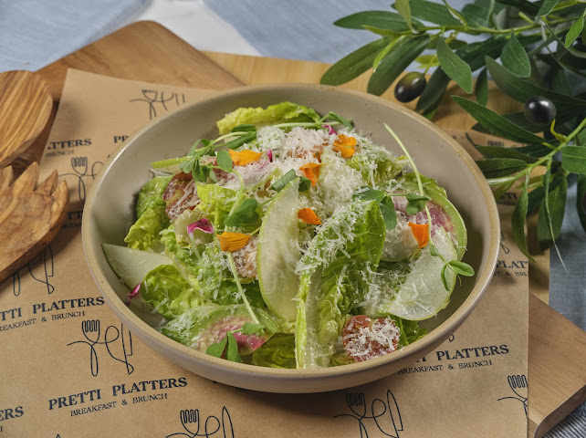 Baby gem lettuce salad with watermelon radish, toasted almonds, and aged Reggiano at Prettiplatters