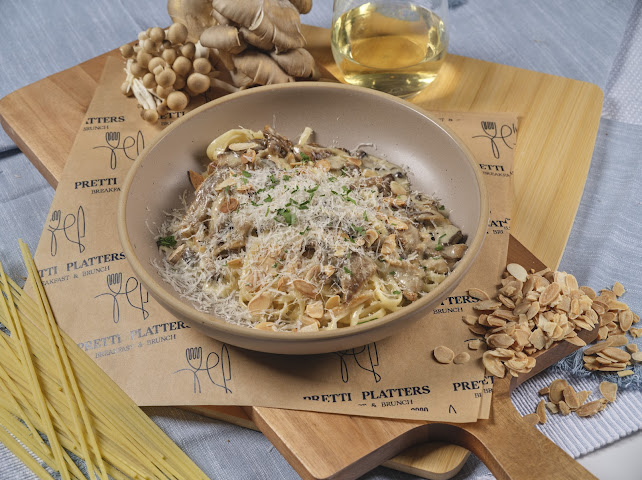 Wild Mushroom Cream Pasta with roasted mushrooms, truffle butter cream, and aged Reggiano at Prettiplatters