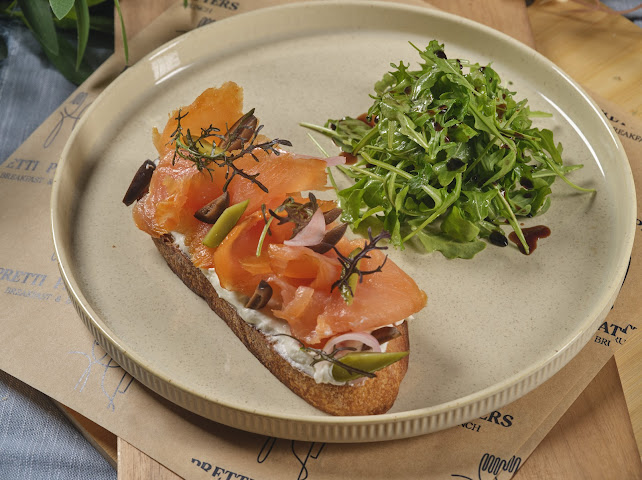 Ora King smoked salmon toast on sourdough with crème fraîche, pickled onions, and fresh dill at Prettiplatters