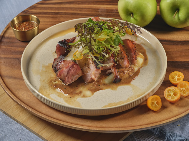 Heritage Pork Chop with celery root purée, green apple, asparagus, and mustard sauce at Prettiplatters